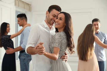 Lovely young couple dancing together at party