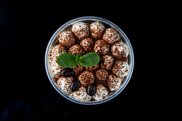 Tiramisu with fresh mint on a background