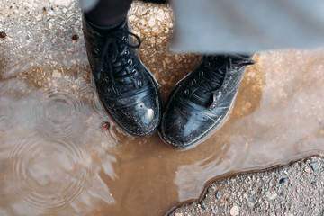 closeup of shoes in a puddle. view from top. protect shoes from moisture.