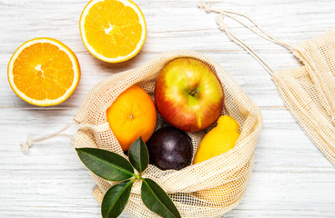 Mesh shopping bag with fruits