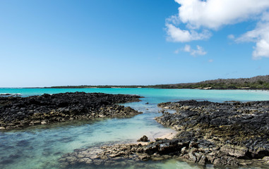 The blue sea and the black rocks