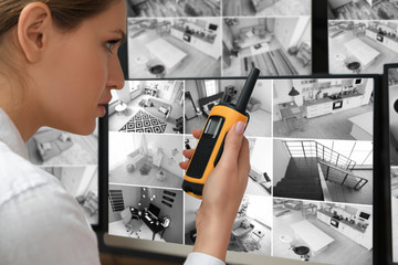 Security guard using portable transmitter at workplace, closeup