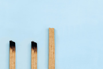 Palo Santo sticks on a blue background. They are used in aromatherapy and religious rites and meditations.