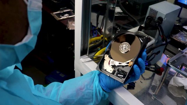 Removing dust of the disk of a broken hard drive in a data recovery center