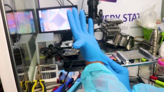 Putting on gloves in a data recovery center