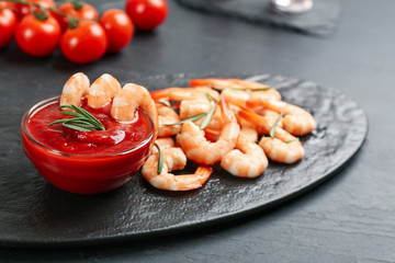 Delicious shrimp cocktail with tomato sauce served on black table