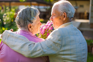 Romantic grandparents 90 years old. Two caucasian senior citizens are embracing each other. Elderly couple marriage  in love