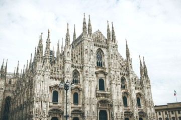 Fototapeta premium Beautiful view of the ancient Duomo Cathedral in Milan in Italy. It is one of the most popular tourist attractions in Italy.