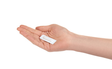 Woman holding suppository on white background. Hemorrhoid problems