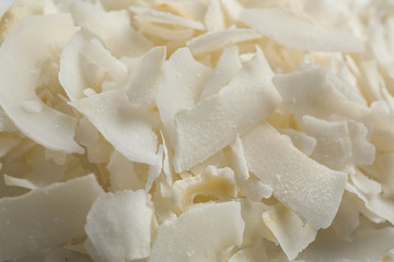 Delicious fresh coconut chips as background, closeup