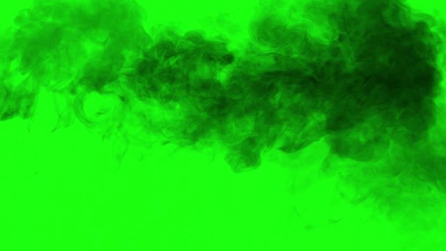 Portion Black Smoke Floats Right. A rare stream of black smoke on a green chroma key slowly fills the screen