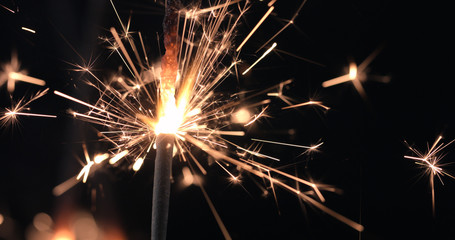 Firework sparkler burning on black background. Merry Christmas and happy new year celebration