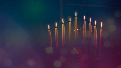 Menorah with lit candles in celebration of Chanukah. A symbolic candle lighting for the Jewish...