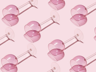Texture of empty wine glasses on a pink background. Creative minimalistic concept.