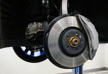 Brake disc and caliper of a modern car. Concept service and repair of a modern luxury car using...