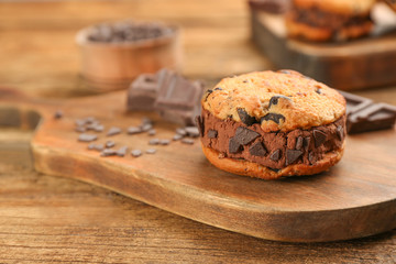 Sweet delicious ice cream cookie sandwich on wooden table