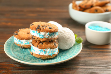 Sweet delicious ice cream cookie sandwiches on wooden table