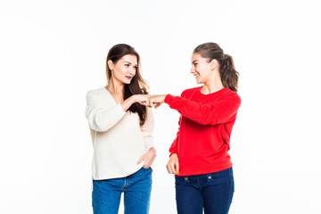 Portrait of two nice-looking attractive teen girls giving five isolated on white background