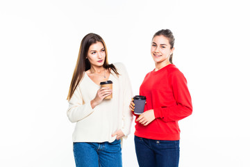 Two smiling students with takeaway coffee standing isolated on white background