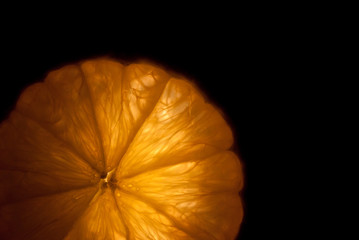 A slice of orange isolated on a black background