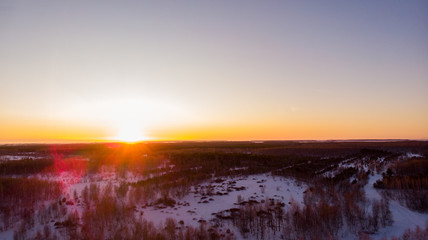 Winter forest, beautiful sunset, aerial view