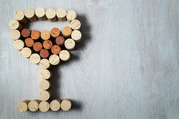 Wine glass laid out from used wine corks.