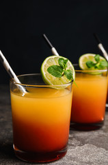 Fresh alcoholic Tequila Sunrise cocktail on grey table