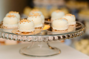 A plate of sweets cakes tarts on the table in the catering business, the meeting of sweetness and lace plates
