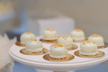 A plate of sweets cakes tarts on the table in the catering business, the meeting of sweetness and lace plates
