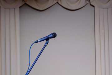 Concert microphone on theatrical background.