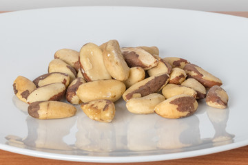 Brazil nuts on white plate.