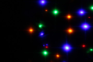 blurry colored lights sparkle like a star. Festive, background.