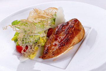 Fried chicken with vegetables, on a white plate. White background.