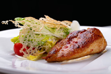 Fried chicken with vegetables, on a white plate. White background.