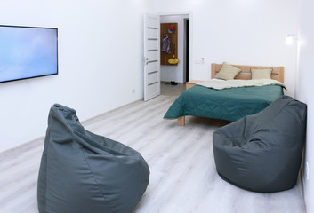 two frameless gray armchairs with tv with double bed scandinavian design, bedrooms, interior, minimalism