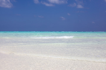 Maldives paradise beach. Perfect tropical island. Moody blue sky and blue lagoon. 