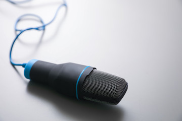 Microphone on light grey background. Journalist's work