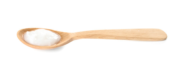 Organic coconut oil in wooden spoon isolated on white. Healthy cooking