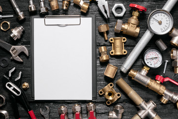 Plumbing flat lay background with copy space. Work tools, pipeline equipment and blank page notepad...
