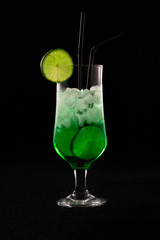 mojito coctail with lime and ice and mint on a black background