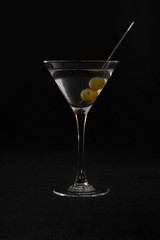 martini cocktail with olives in a transparent triangular glass