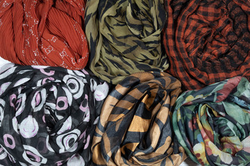 Close-up. Background, texture. Six multi-colored fabrics folded together.