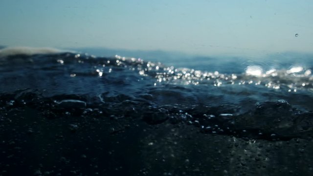 Sea level from moving glass boat. Prores 422 10 Bit slow motion.