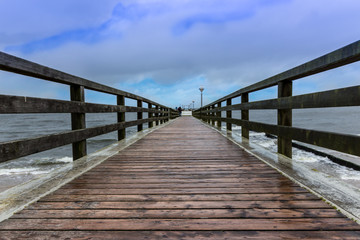 wooden pier and clouds in the sky