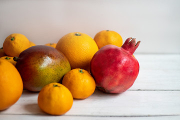 Fruit. Orange, pomegranate, mandarin, mango. Fruit on a white background. Eco-friendly fruits, zero waste.
