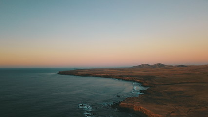 Landscape and sunset on the coast contemplating the breaking of the waves on the cliffs