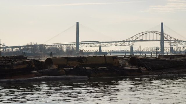 Patullo Bridge behind Log Booms in the Fraser River