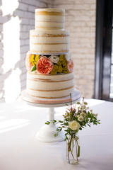 wedding cake on bouquet of flowers
