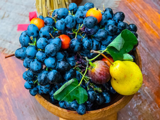 Blue grapes and pears in a vase. Fruit composition.