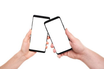 Two hands holding smartphones blank screen with modern frameless design while wireless transferring data NFC connected isolated on white background